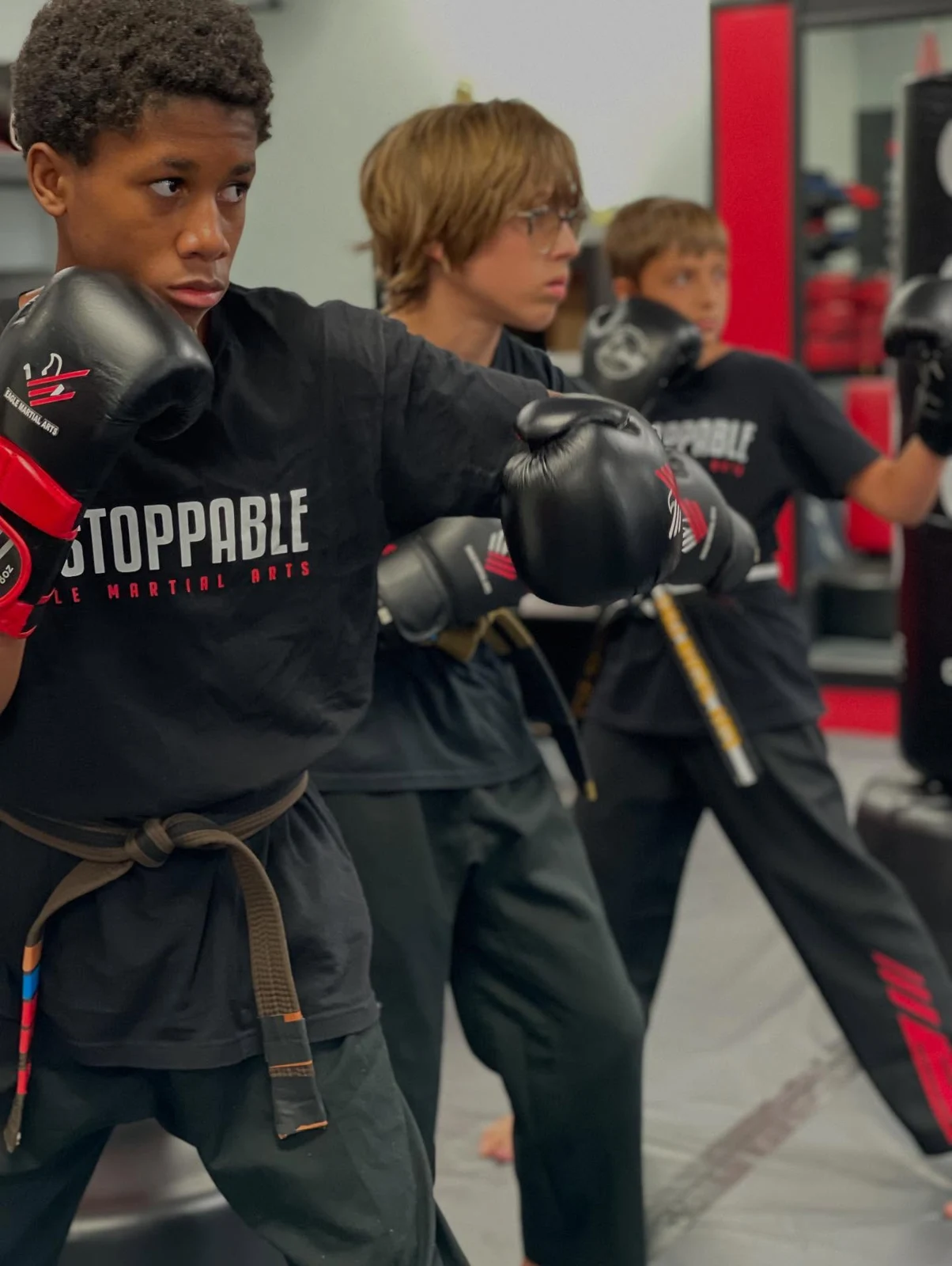 Older youth students practicing punches in class
